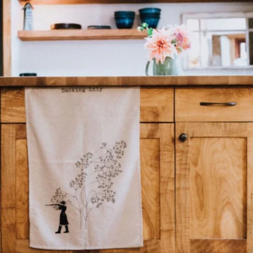 Home Goods | Elizabeth Homestead (beautiful tea towel hanging in front of light wood cabinets)